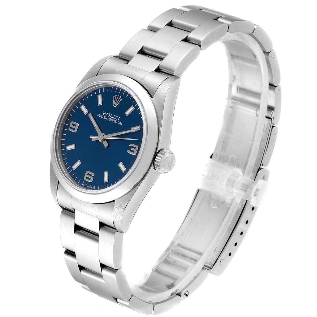 The Mid-Size Rolex watch is shown from an angled side view, highlighting the blue dial, bezel, and metal bracelet.
