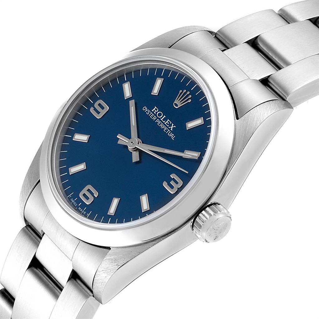This image shows a close-up of the dial, bezel, crown, and bracelet of a Rolex Mid-Size 67480 Women's Stainless Steel Blue Dial 67480 Women's Stainless Steel Blue Dial Oyster Perpetual watch, viewed from a slight angle.