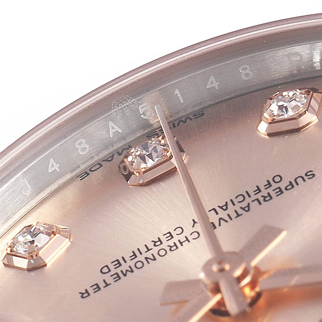 This close-up angle of the Rolex Mid-Size 178271 Women's Steel and Gold (two tone) Pink Dial 178271 Women's Steel and Gold (two tone) Pink Dial watch shows the dial with diamond hour markers and part of the minute hand.
