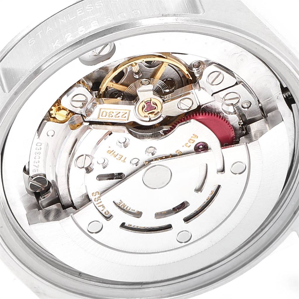 The image shows the internal mechanism of a Mid-Size Rolex watch, including the movement gears and balance wheel.