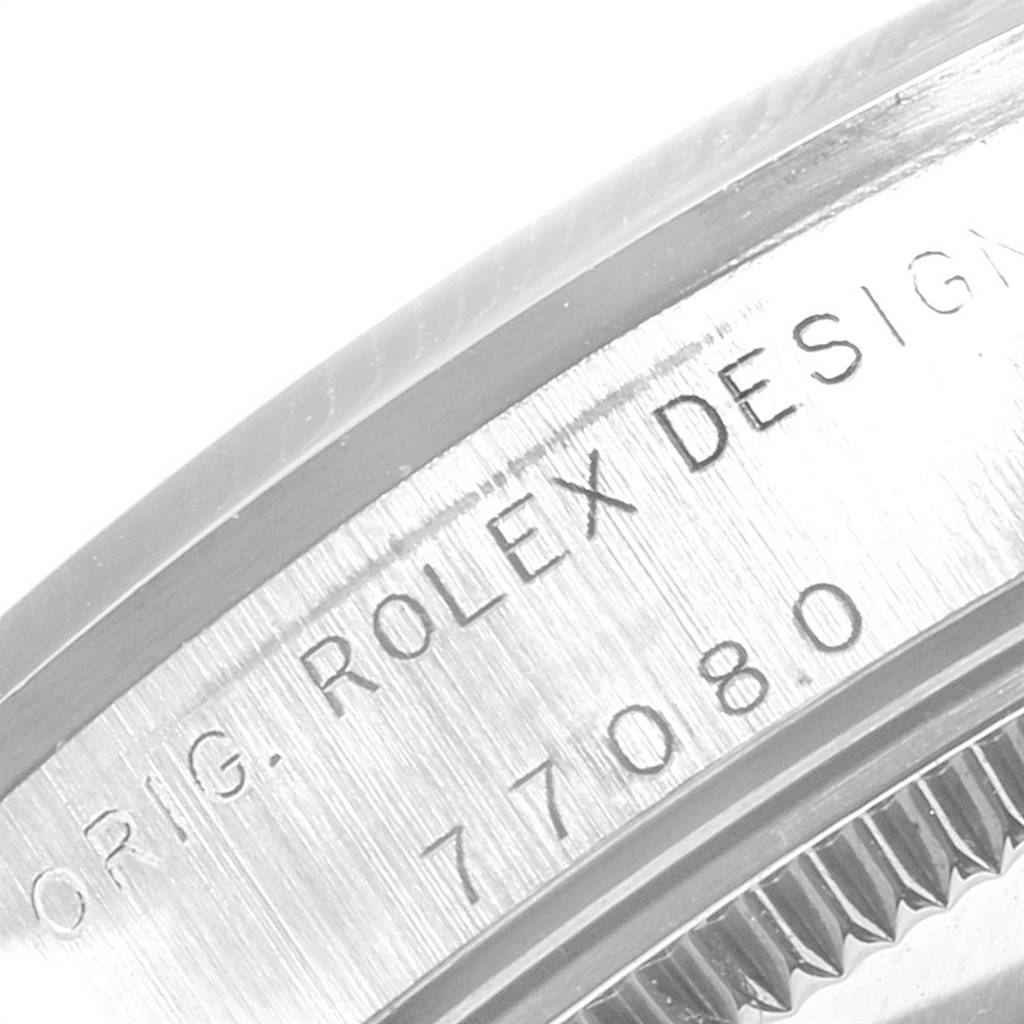 The image shows a close-up view of the case back and serial number of a Mid-Size Rolex watch model 7708.0.