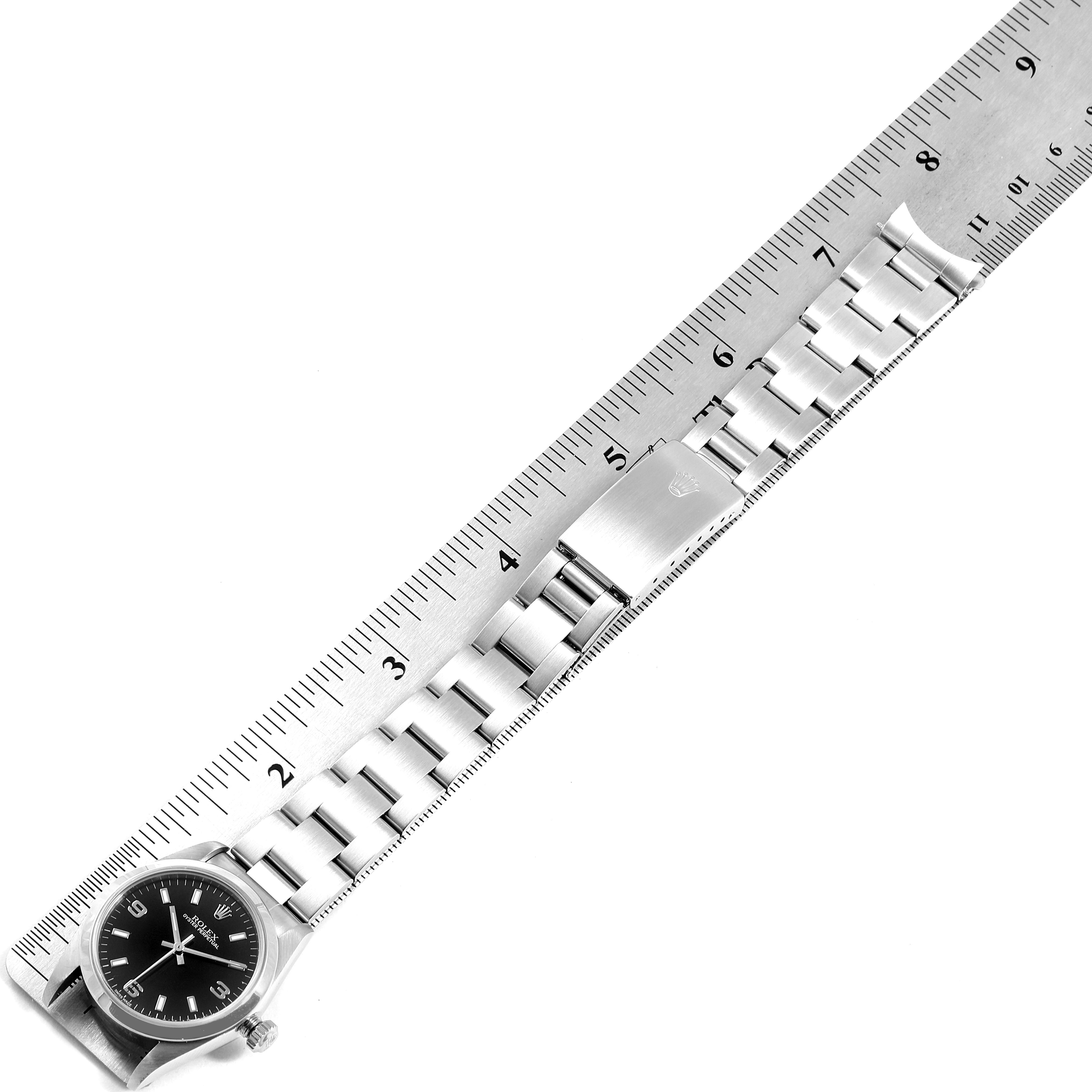 The image shows the face and bracelet of a Mid-Size Rolex watch alongside a measuring ruler.