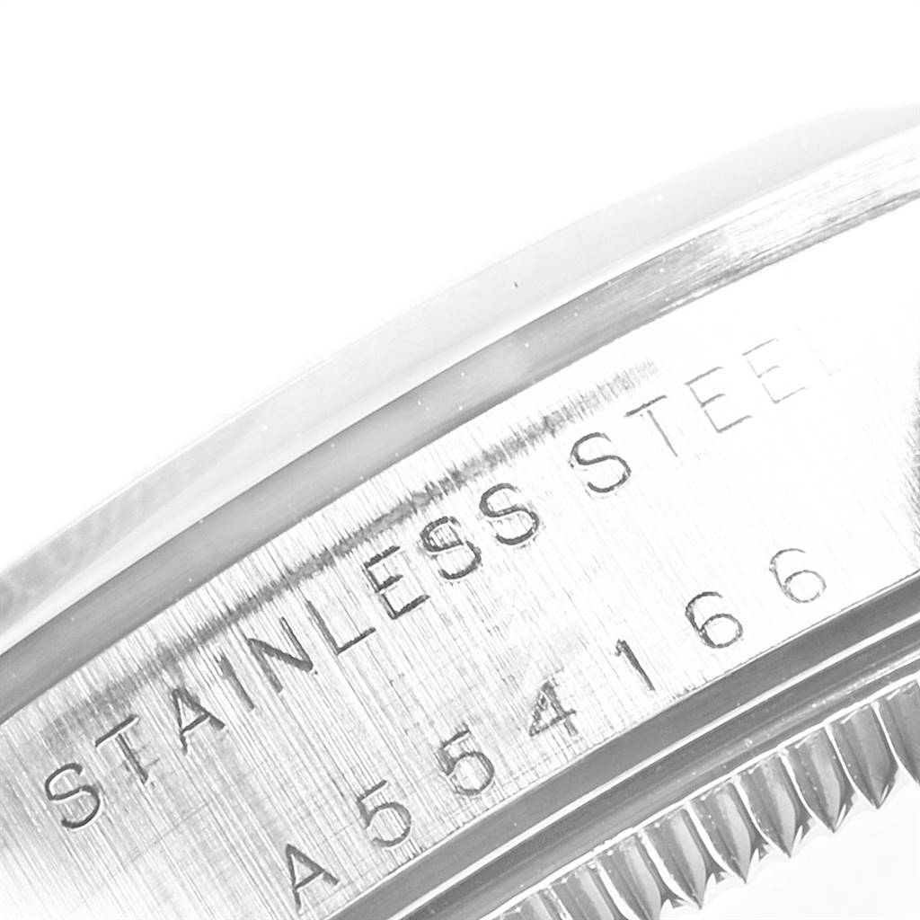 The image shows a close-up of the case side and bezel of a Rolex Mid-Size 77080 Women's Stainless Steel Black Dial 77080 Women's Stainless Steel Black Dial model, displaying the "STAINLESS STEEL" engraving and serial number.
