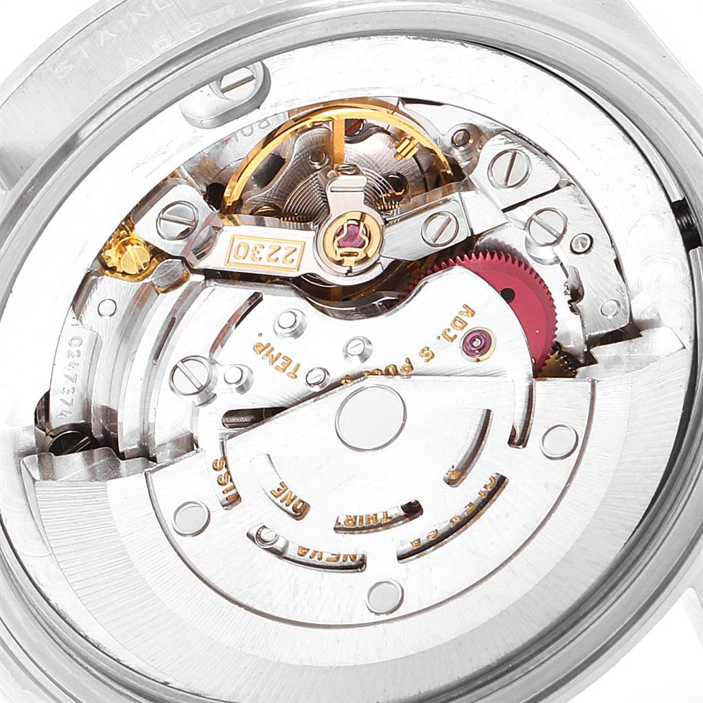 The image shows the internal mechanism of a Rolex Mid-Size 77080 Women's Stainless Steel Black Dial 77080 Women's Stainless Steel Black Dial watch, highlighting gears and components of its movement.