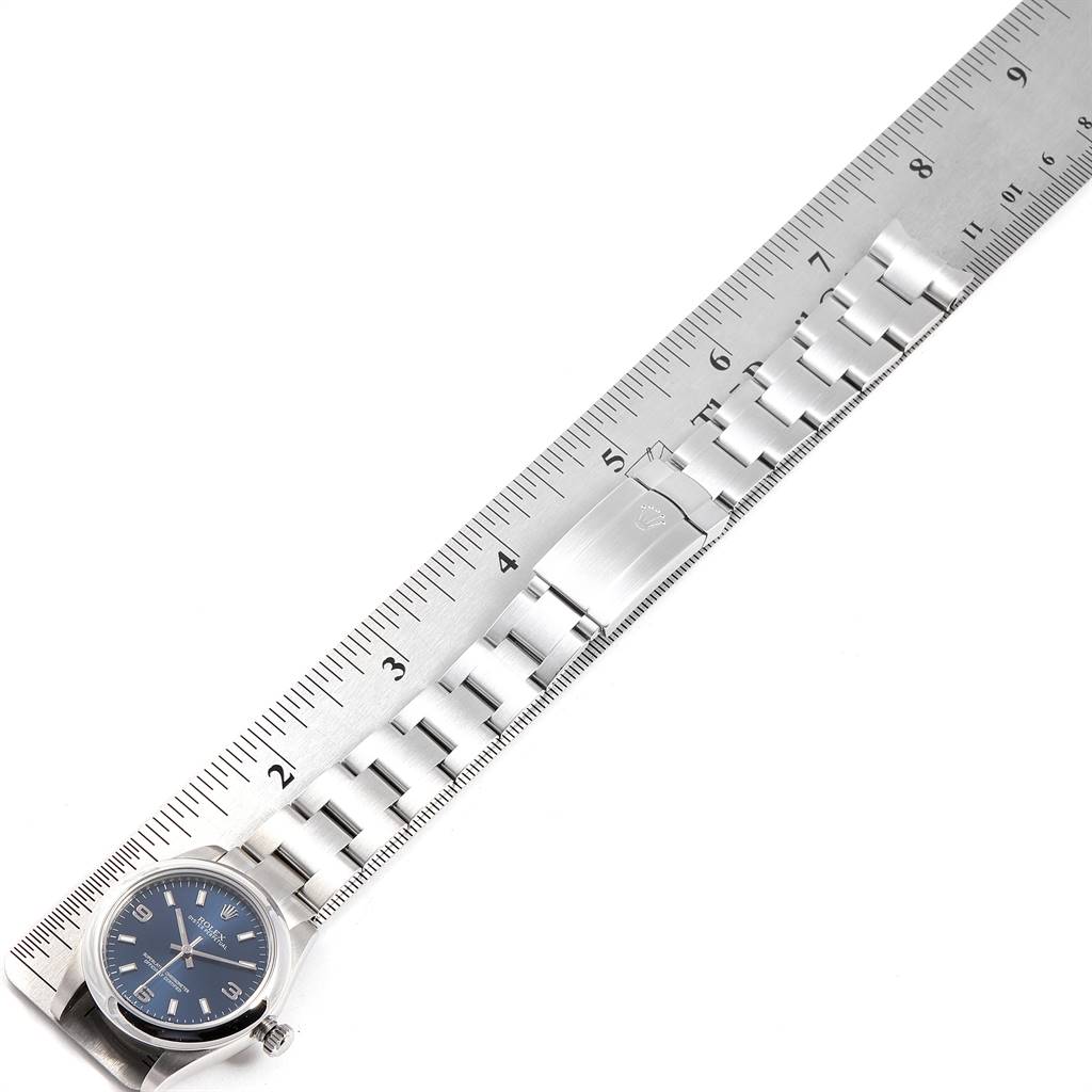 The image shows a Mid-Size Rolex watch with a metal bracelet alongside a ruler, highlighting its length.