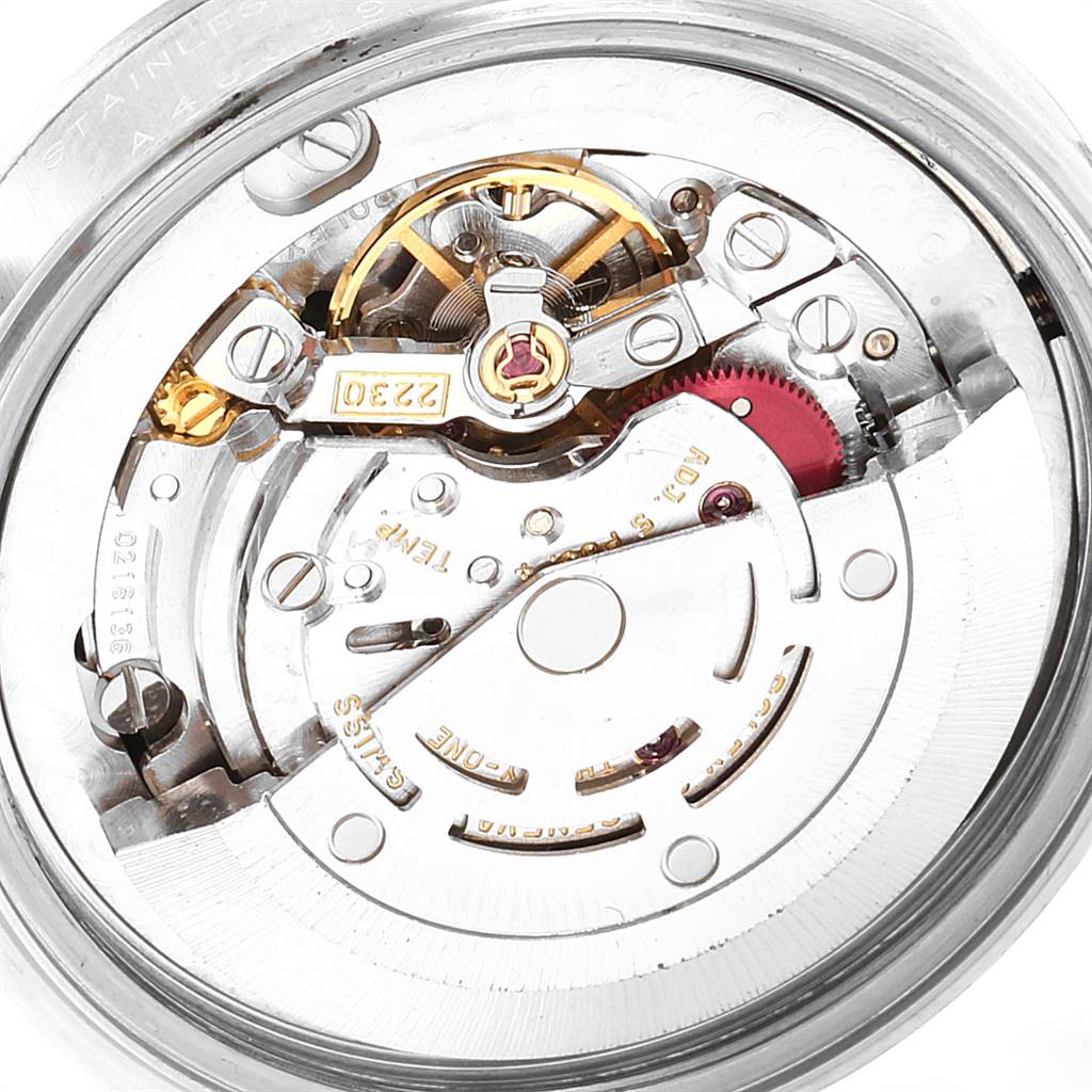 This image shows the internal mechanism, including gears and balance wheel, of a Rolex Mid-Size 77080 Women
s Stainless Steel Black Dial 77080 Women
s Stainless Steel Black Dial watch from a top angle.