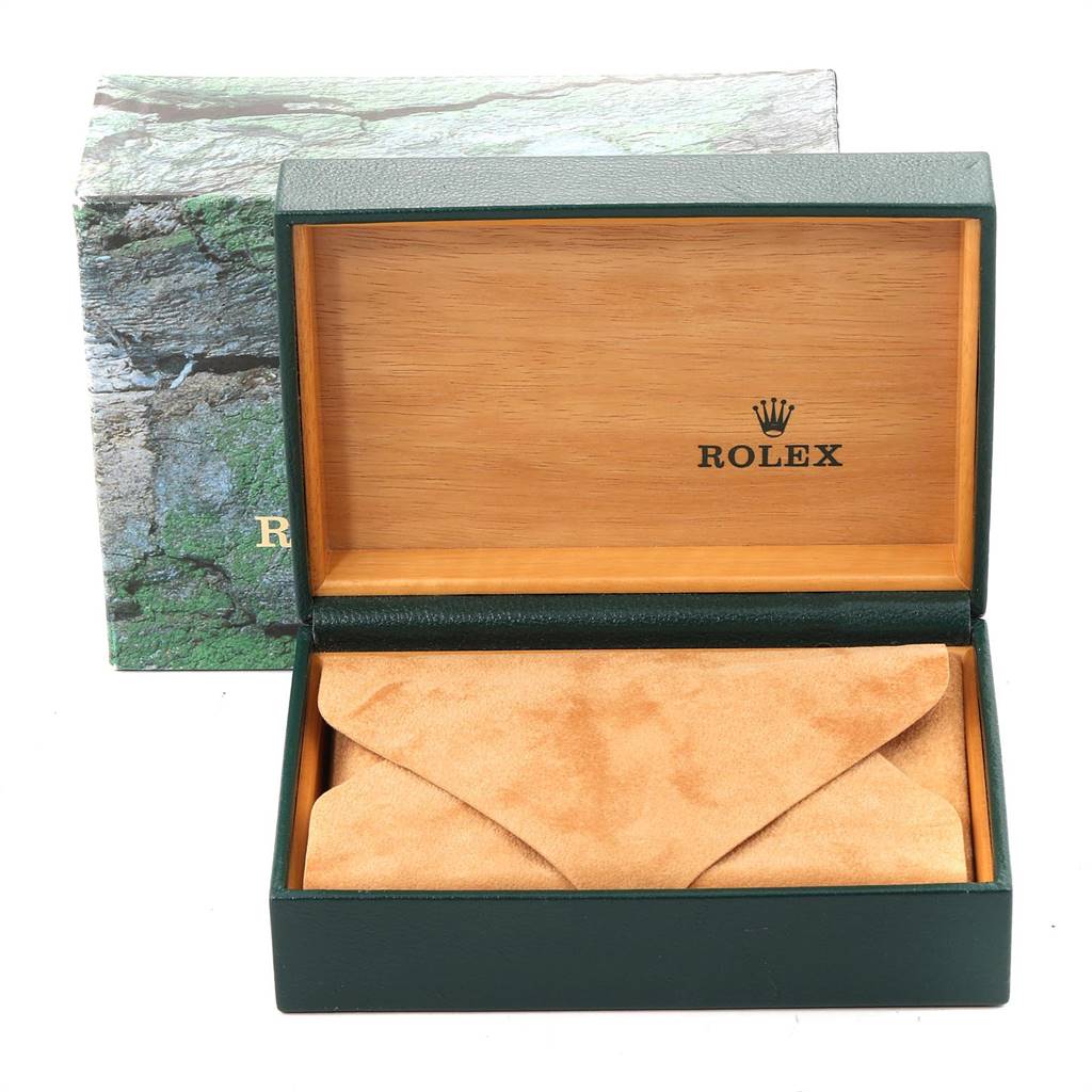 The image shows a Rolex Mid-Size 77080 Women
s Stainless Steel Black Dial 77080 Women
s Stainless Steel Black Dial watch box, open to reveal a tan suede interior accessory pouch, with the logo visible.