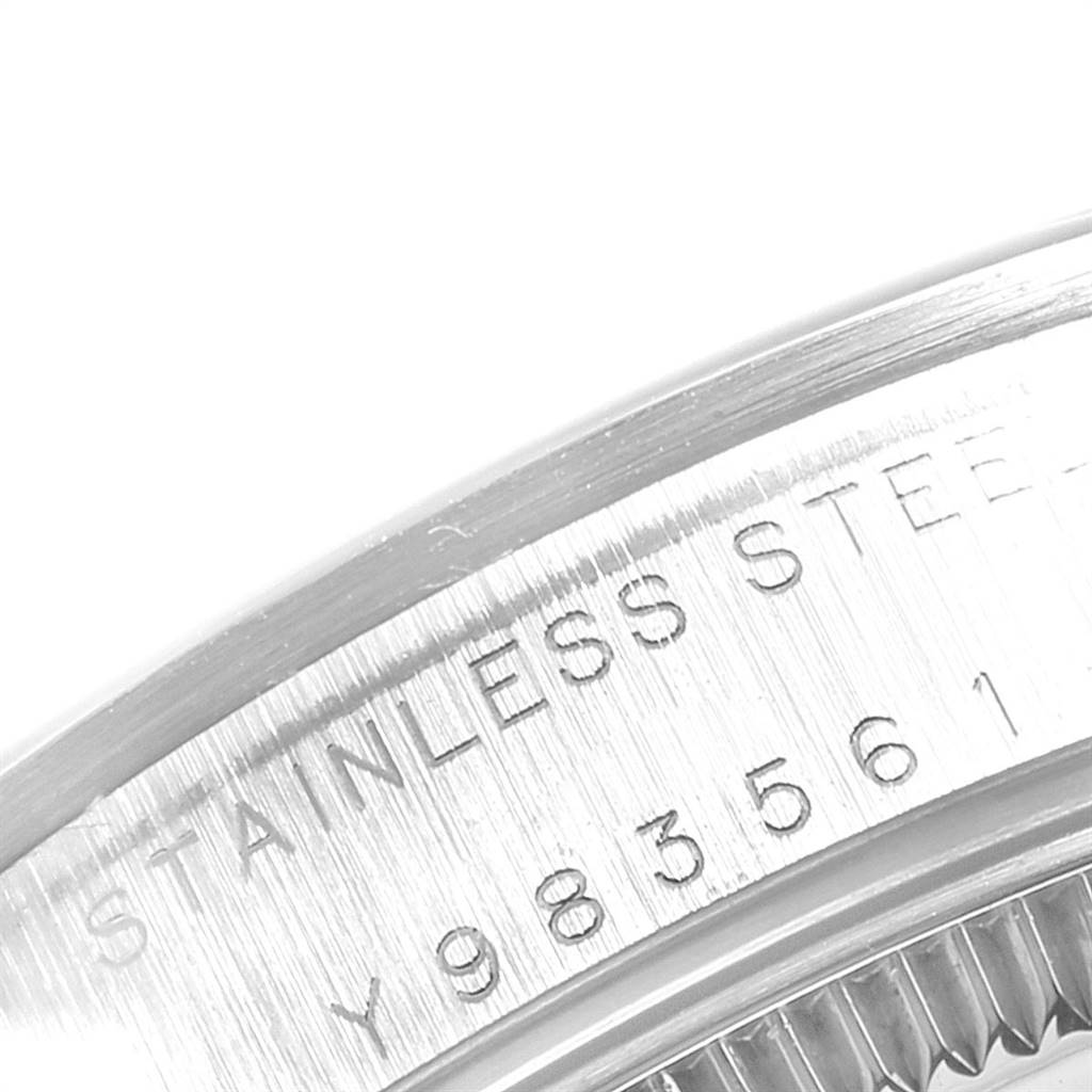 This image shows a close-up of the engraved case back of a Mid-Size Rolex watch, featuring a stainless steel inscription.