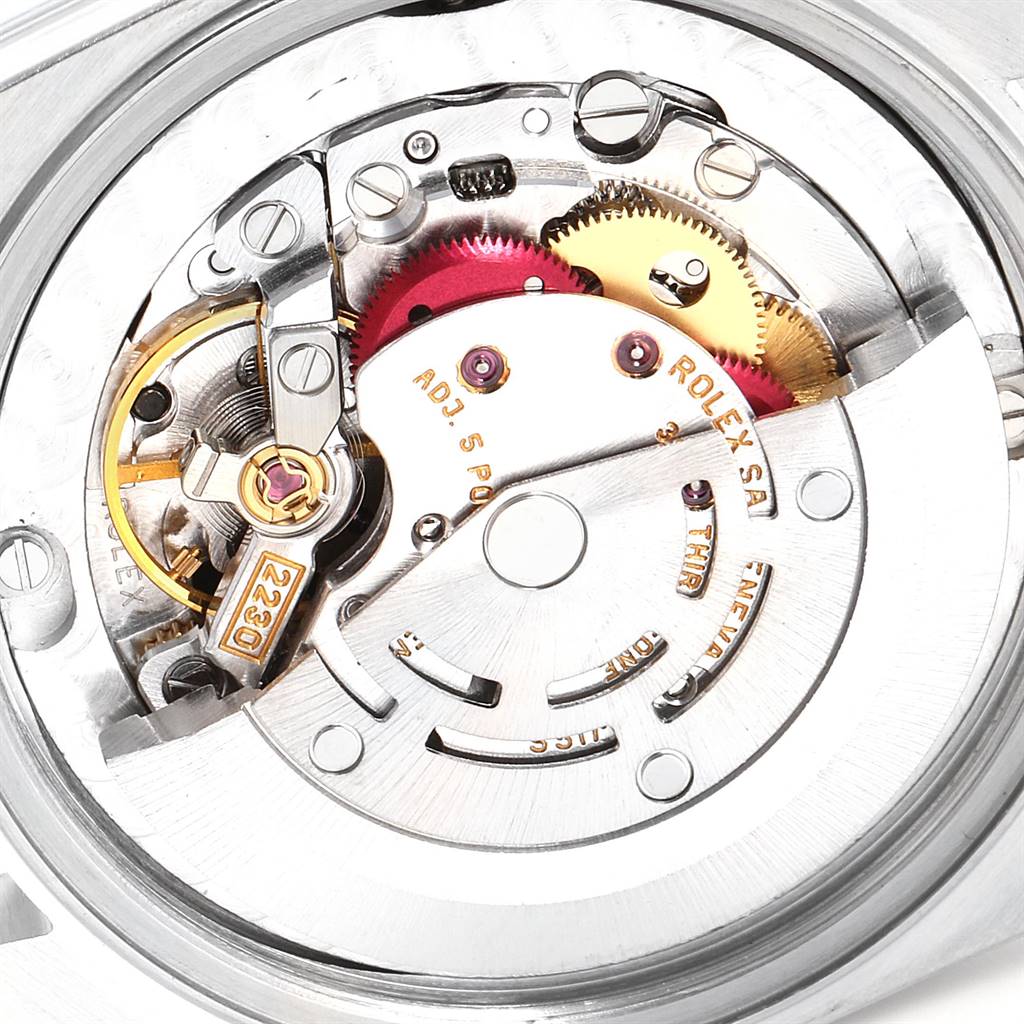 This image shows the inner mechanism of a Rolex Mid-Size 77080 Women's Stainless Steel Black Dial 77080 Women's Stainless Steel Black Dial watch from an aerial view, prominently featuring its gears and intricate components.