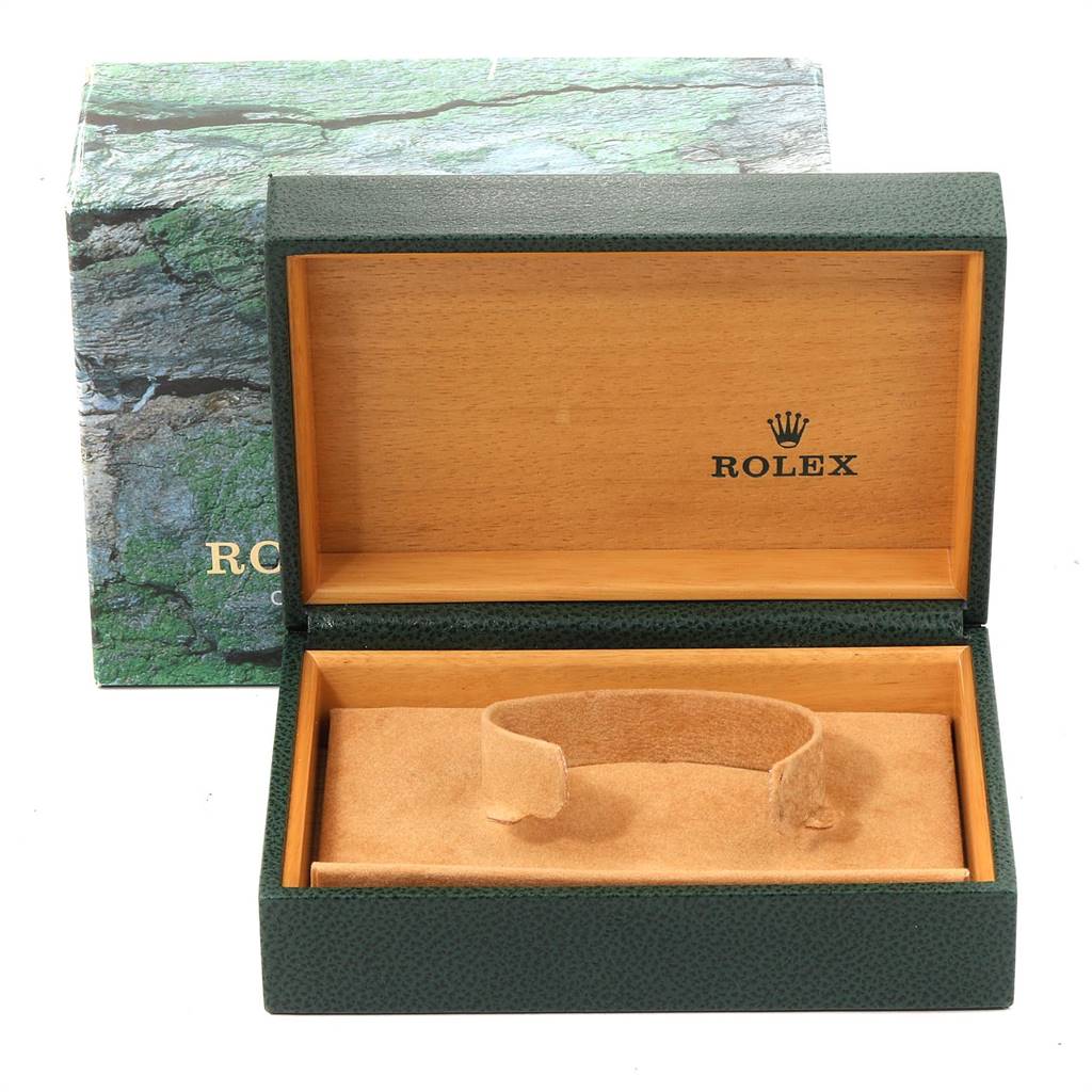 This image shows an open Rolex Mid-Size 77080 Women's Stainless Steel Black Dial 77080 Women's Stainless Steel Black Dial watch case with interior branding and a cushion, against a partially visible branded box.