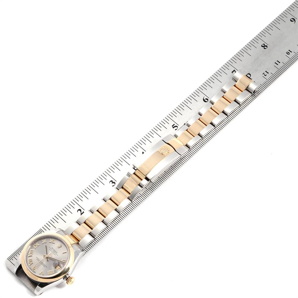 The Rolex Mid-Size 178243 Women's Stainless Steel Grey Dial 178243 Women's Stainless Steel Grey Dial model is shown from an overhead angle, displaying its face and full bracelet alongside a ruler for scale.