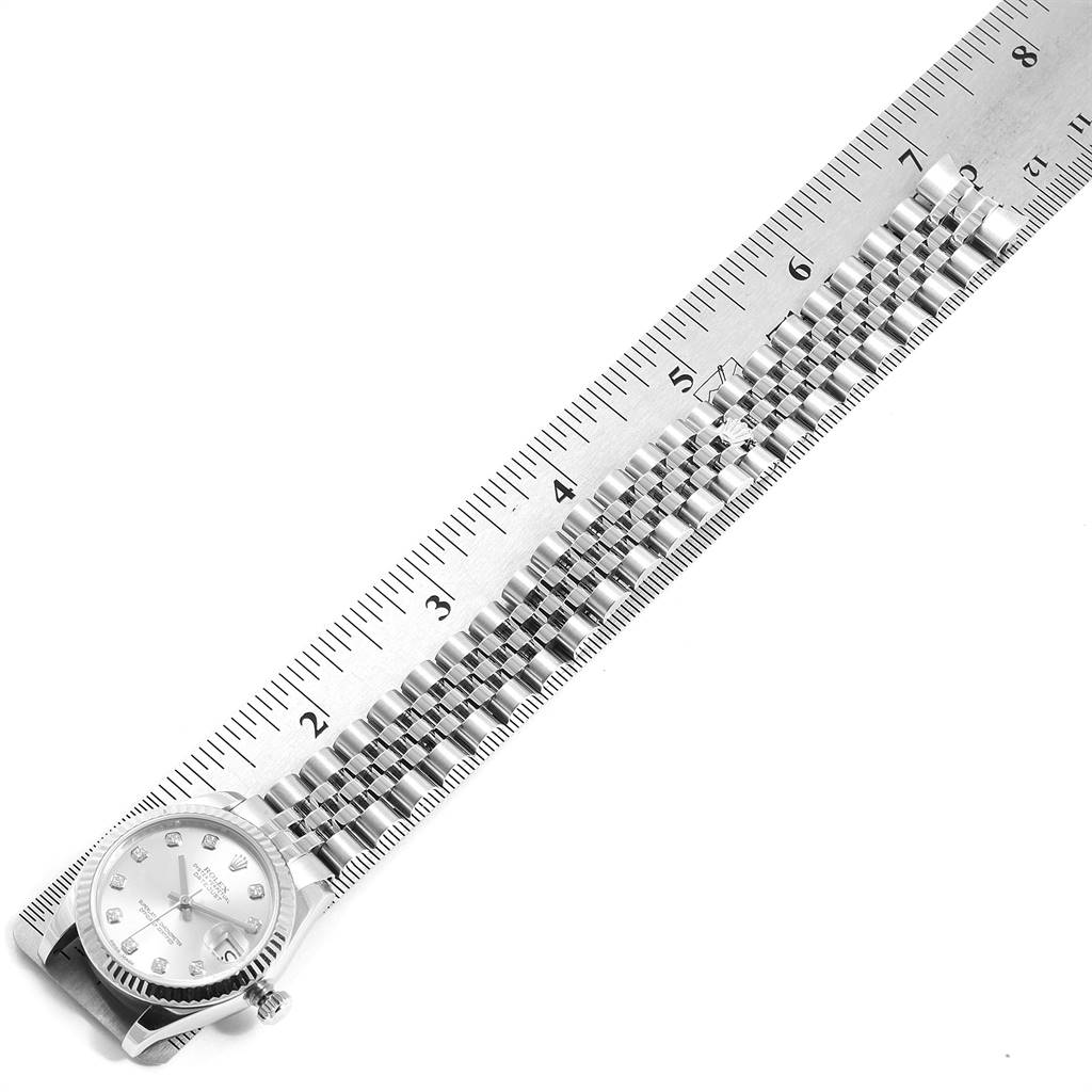 The image shows the Rolex Mid-Size 178274 Women's Stainless Steel Silver Dial 178274 Women's Stainless Steel Silver Dial model watch laid flat with its face and bracelet alongside a ruler for scale.