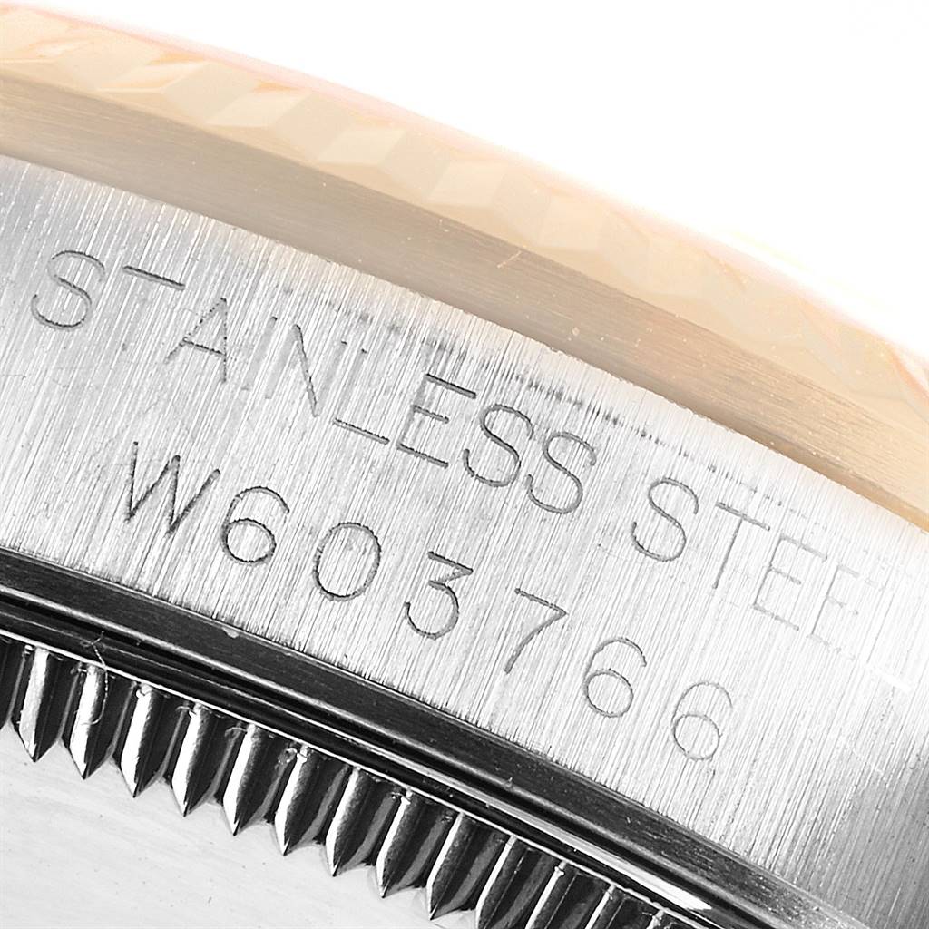 The image shows a close-up of the side of a Rolex Mid-Size 68273 Women's Steel and Gold (two tone) Champagne Dial 68273 Women's Steel and Gold (two tone) Champagne Dial model, revealing the serial number engraved on the stainless steel casing.