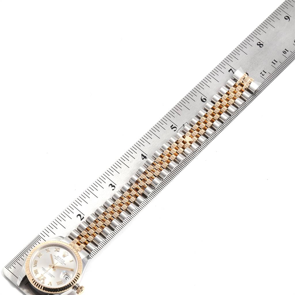 The image shows a Rolex Mid-Size 178273 Women's Steel and Gold (two tone) Silver Dial 178273 Women's Steel and Gold (two tone) Silver Dial watch laid flat next to a ruler, highlighting the watchband length.