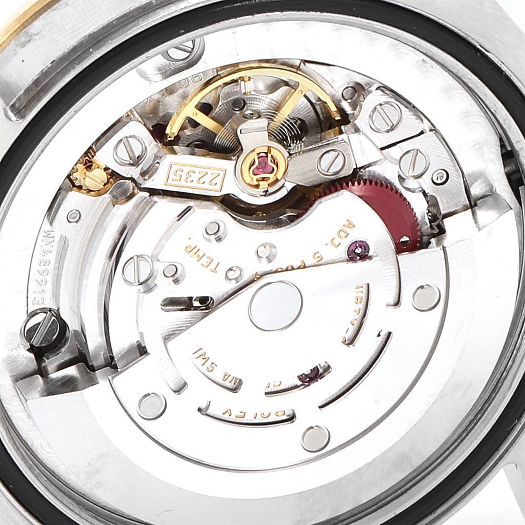 This close-up image shows the inner mechanical movement of a Mid-Size Rolex watch.