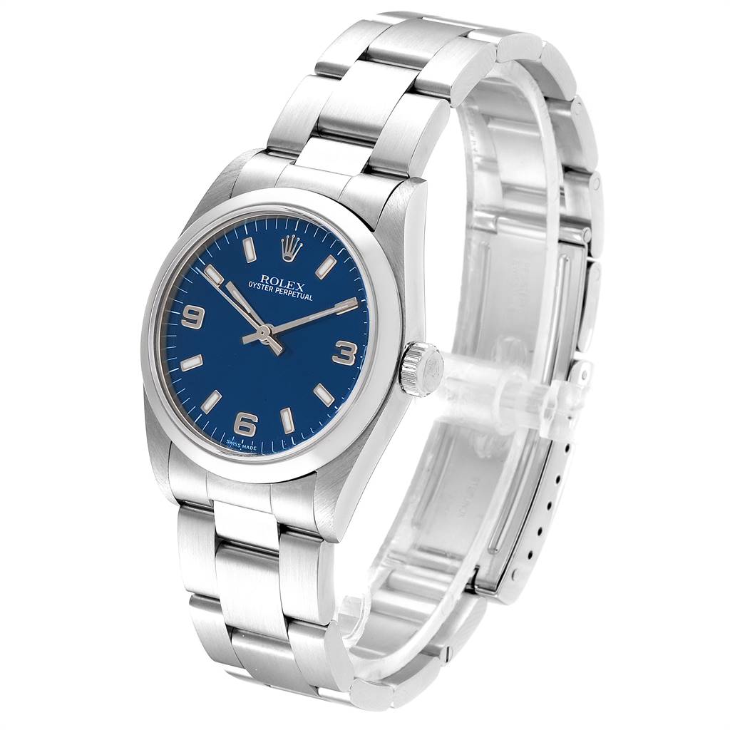 The Mid-Size Rolex Oyster Perpetual watch is shown at a slight angle, displaying the blue dial, crown, and stainless steel link bracelet.