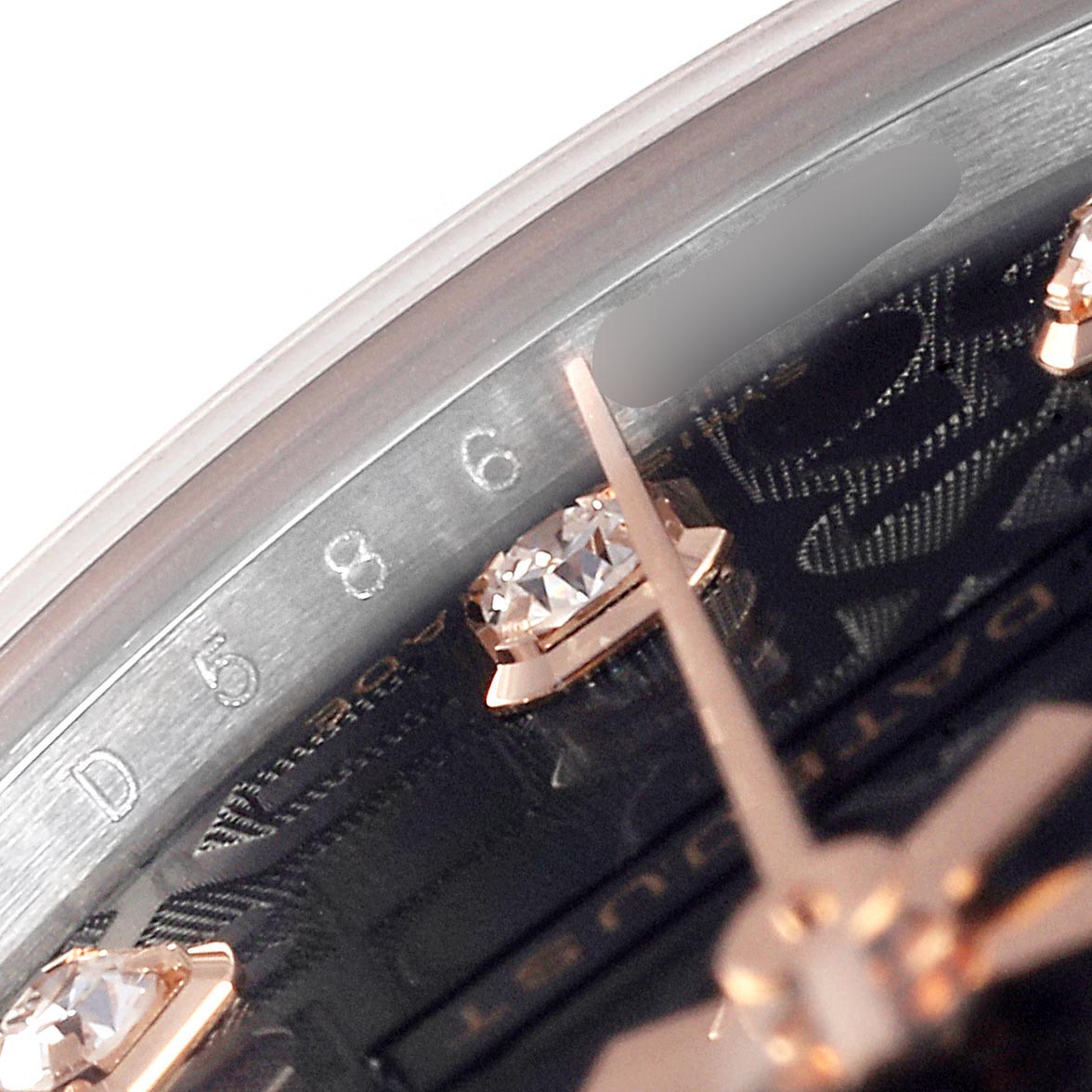 This close-up image of a mid-size Rolex watch shows part of the dial, a diamond hour marker, and the hour hand.