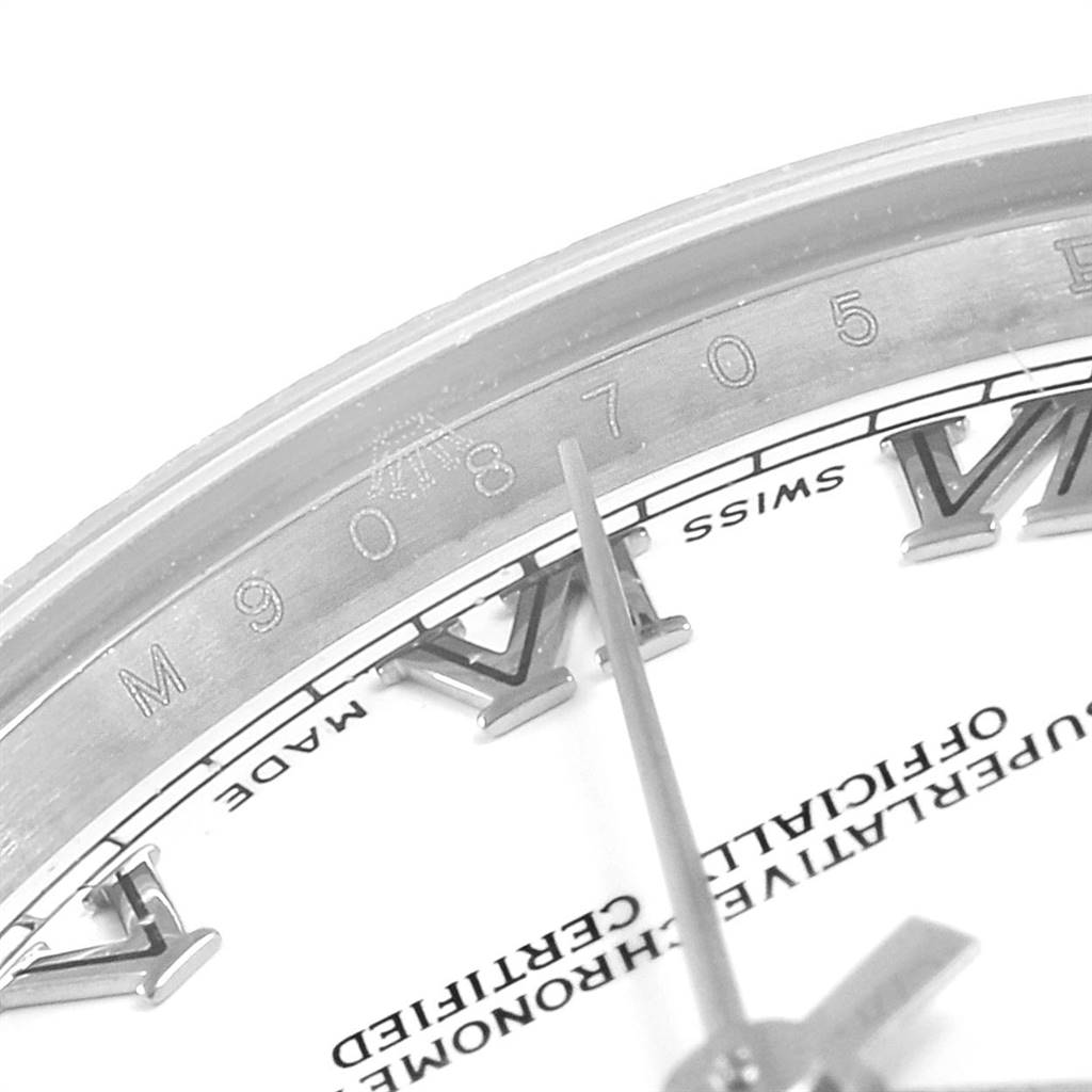 This close-up angle of the Rolex Mid-Size 178274 Women's Stainless Steel White Dial 178274 Women's Stainless Steel White Dial watch shows the partial dial, Roman numeral markers, and serial number on the inner bezel.