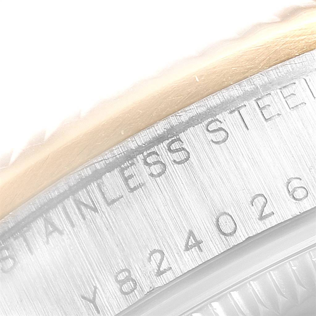 The image shows a close-up of the side of a Mid-Size Rolex watch, highlighting the stainless steel engraving on the case.