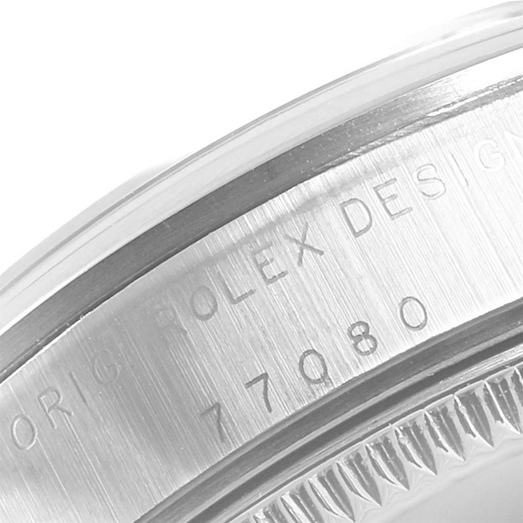 This image shows a close-up of the engravings on the side of a Mid-Size Rolex watch case.