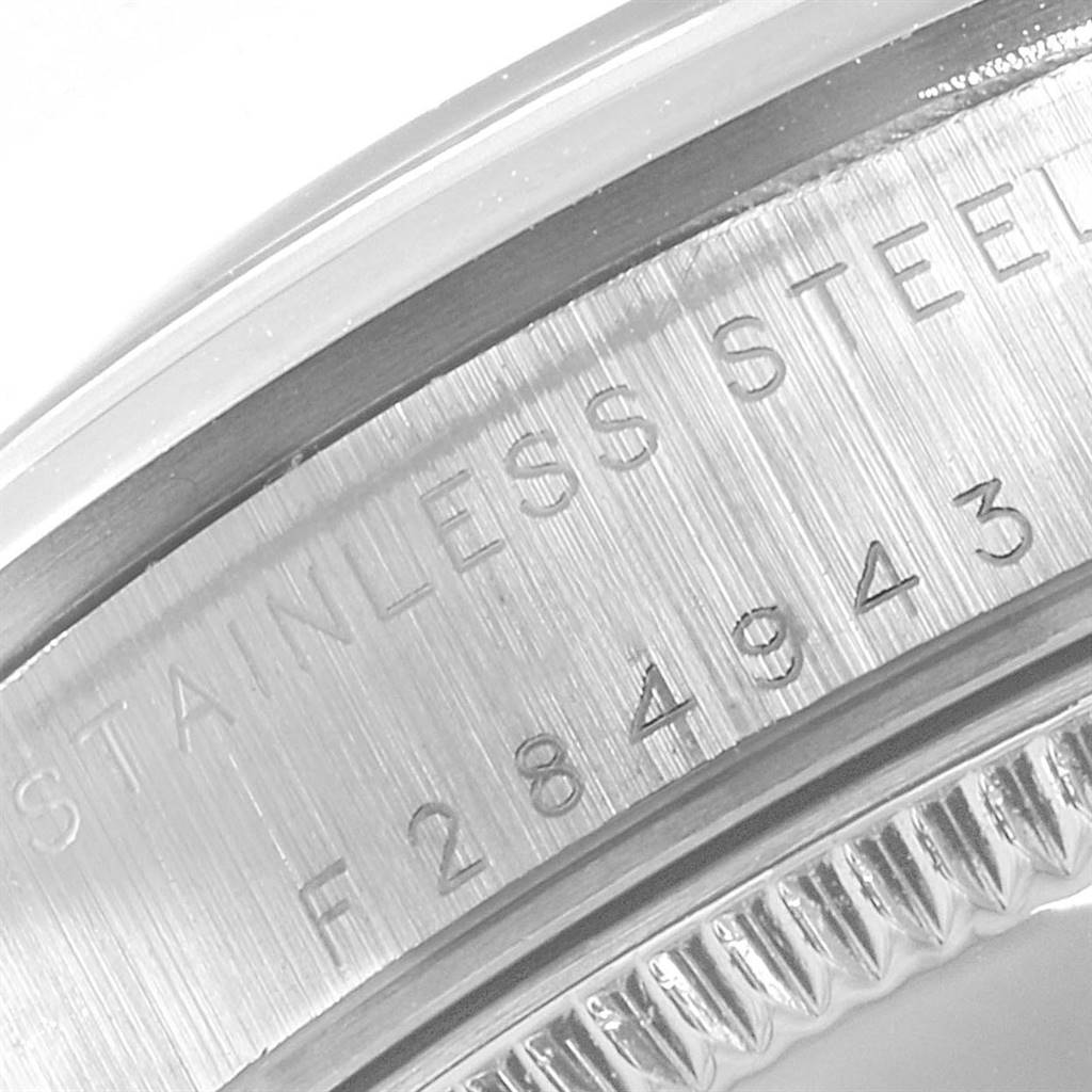 The image shows a close-up of the case back edge, revealing the model and serial number of the Rolex Mid-Size 77080 Women's Stainless Steel Pink Dial 77080 Women's Stainless Steel Pink Dial watch.