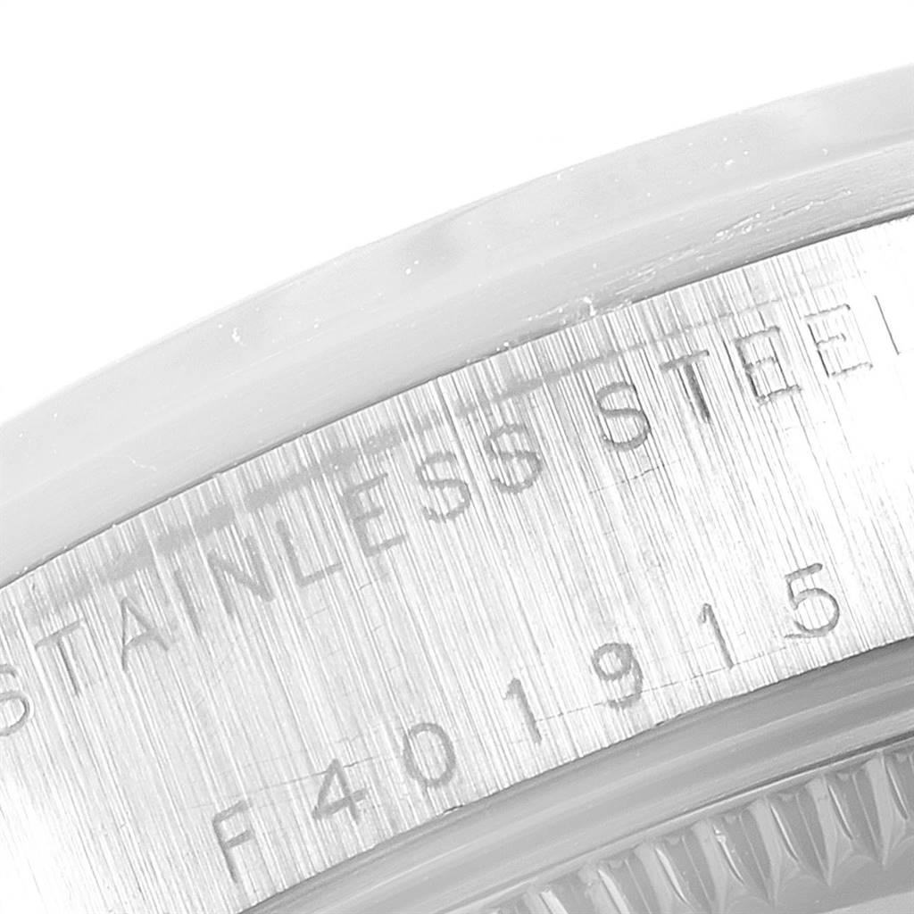 The image shows a detailed close-up of the stainless steel case back with serial engraving of a Mid-Size Rolex watch.