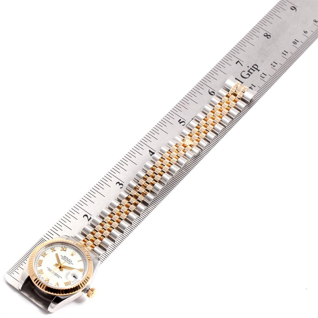 The Rolex Mid-Size 178273 Women's Steel and Gold (two tone) White Dial 178273 Women's Steel and Gold (two tone) White Dial watch is seen flat, showing the dial, bezel, and full band alongside a ruler for scale.