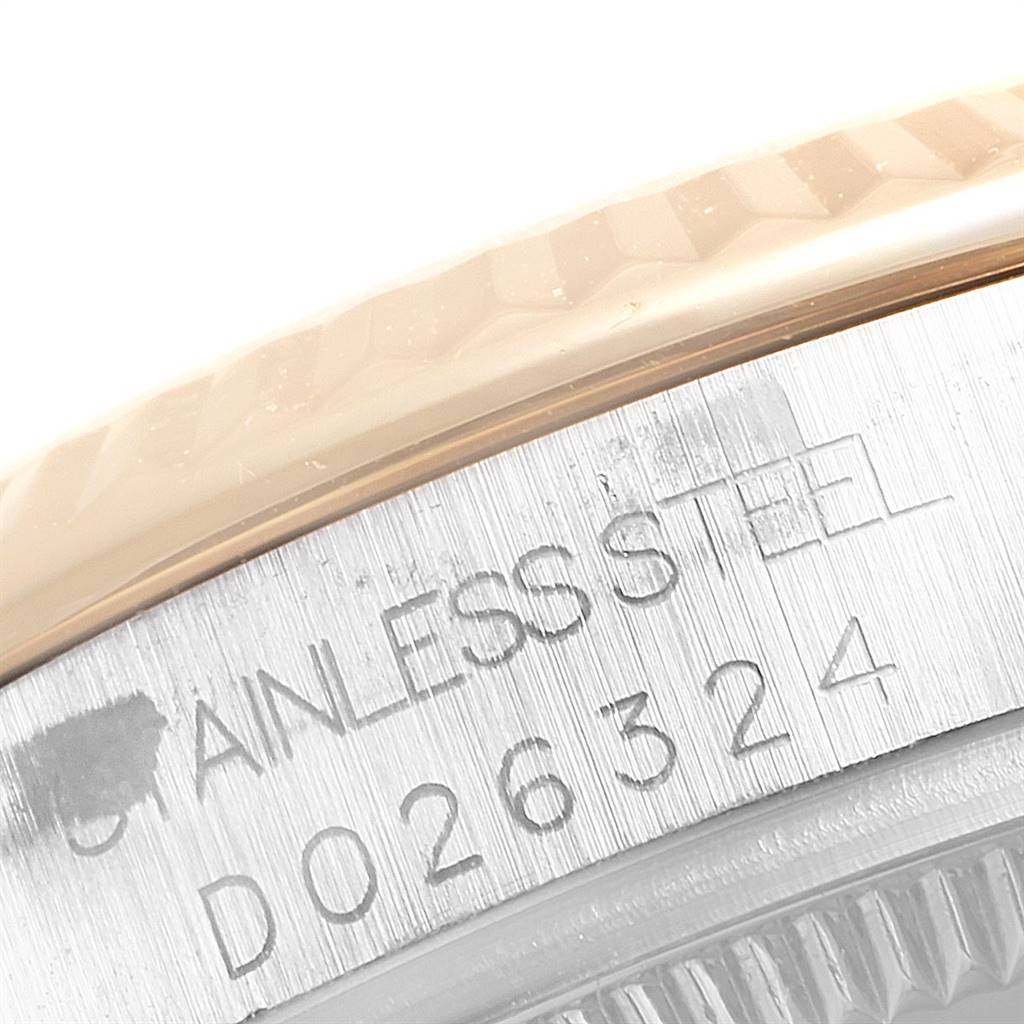 The image shows a close-up of the stainless steel case back of a Mid-Size Rolex watch, highlighting the engraving.