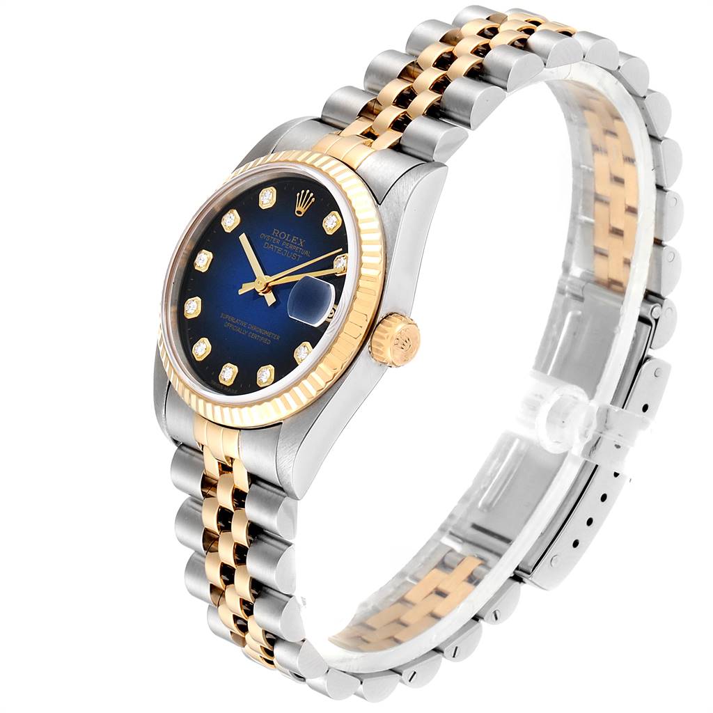 The image shows a Rolex Mid-Size 68273 Women's Steel and Gold (two tone) Blue Dial 68273 Women's Steel and Gold (two tone) Blue Dial Datejust watch at a slight side angle, highlighting its two-tone bracelet, blue dial, and fluted bezel.