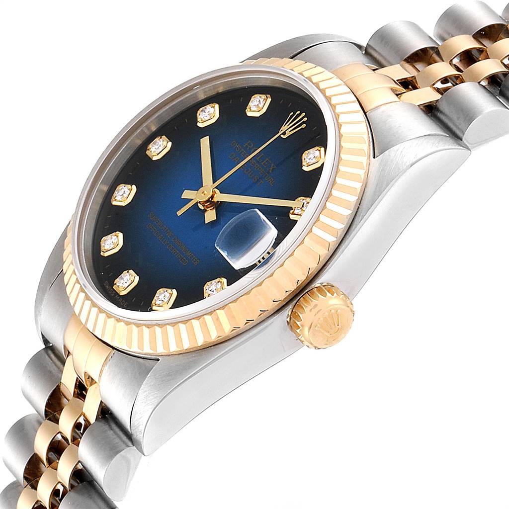 This image shows a Rolex Mid-Size 78273 Women's Steel and Gold (two tone) Blue Dial 78273 Women's Steel and Gold (two tone) Blue Dial watch at an angle, highlighting its dial, fluted bezel, crown, and bracelet.