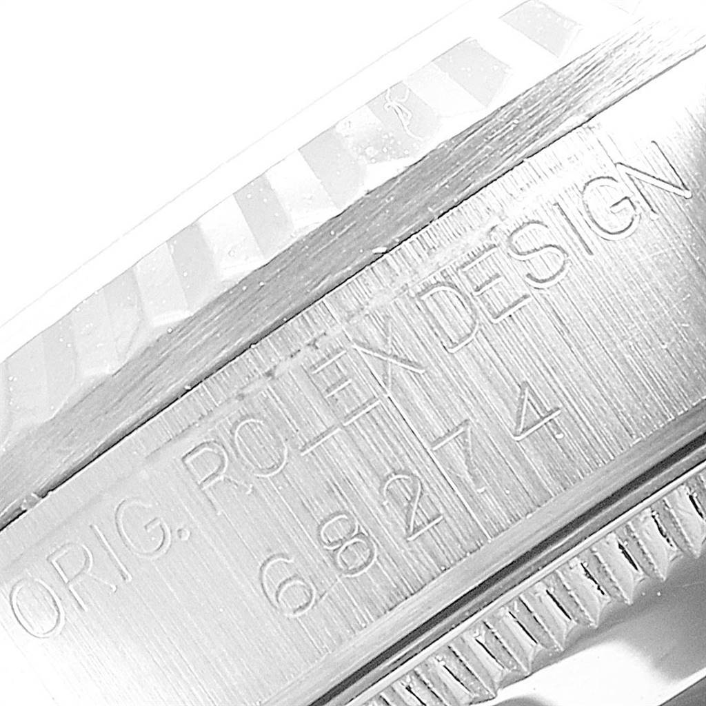 This image shows a close-up angle of the case and bezel side of a Rolex Mid-Size 68274 Women's Stainless Steel Silver Dial 68274 Women's Stainless Steel Silver Dial watch, featuring the engraved model details.