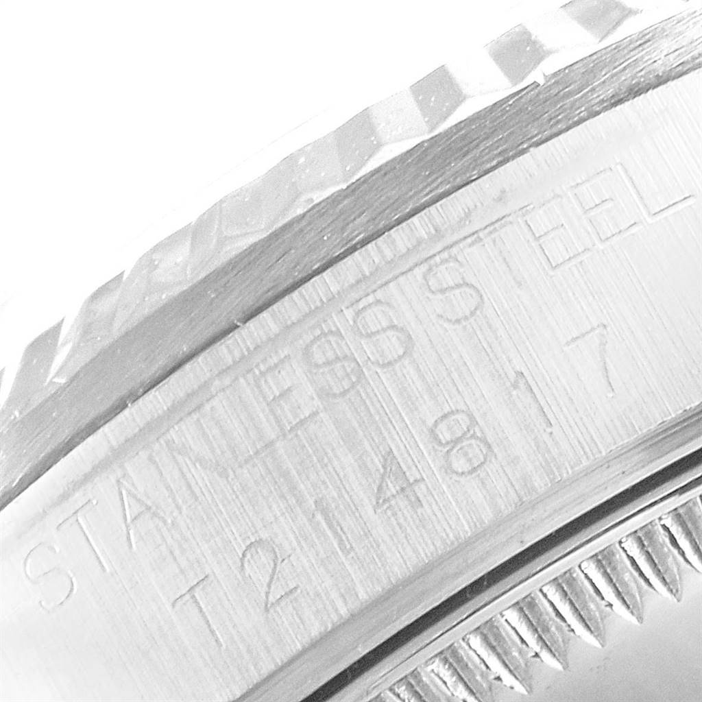 This close-up image shows the engraved stainless steel case and bezel of a Mid-Size Rolex watch.