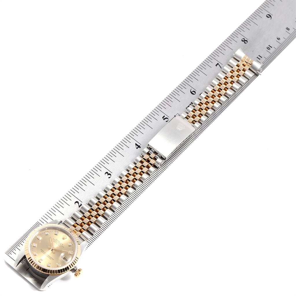 This image shows a Mid-Size Rolex watch straight-on, displaying the dial and full bracelet length next to a measuring ruler.