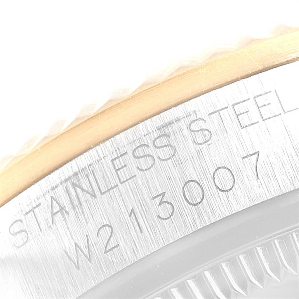 The image shows a close-up of the side of a Mid-Size Rolex watch, featuring the stainless steel case and partial engravings.