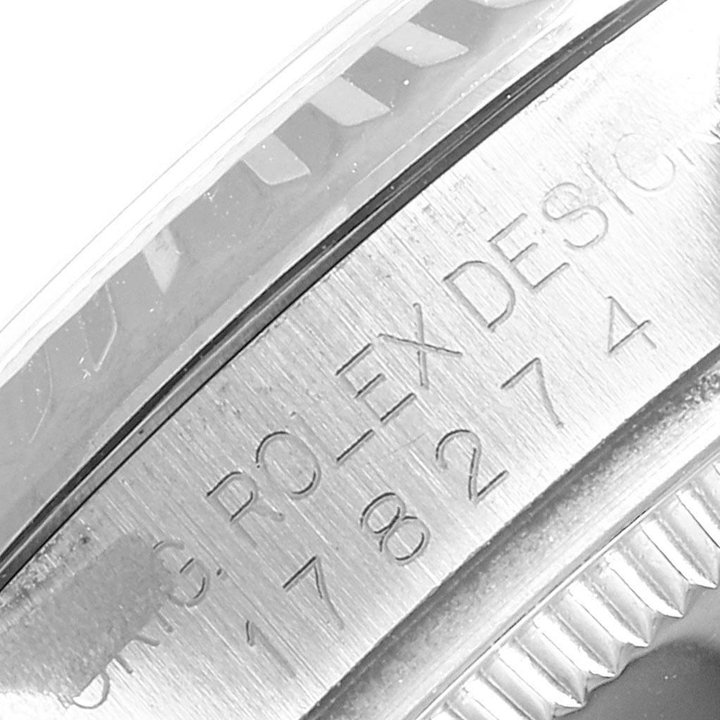The image shows a close-up angle of the bezel and case edge of a Rolex Mid-Size 178274 Women's Stainless Steel White Dial 178274 Women's Stainless Steel White Dial model, focusing on the engraved text.