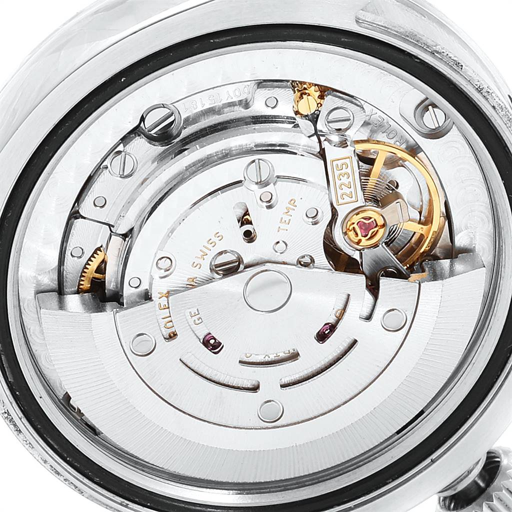 The image shows the inner mechanical movement of a Mid-Size Rolex watch, highlighting the intricate gears and components.