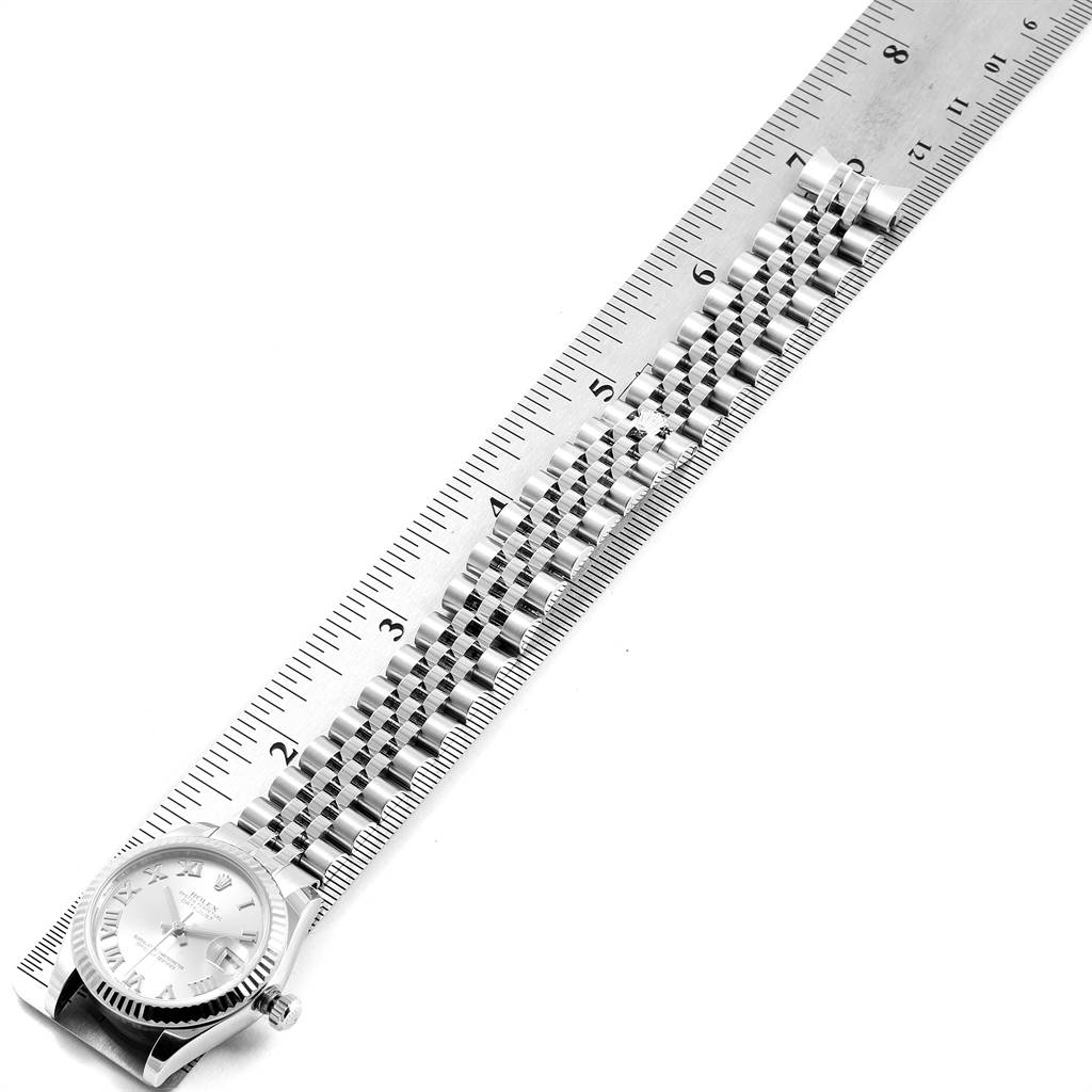 The Rolex Mid-Size 178274 Women's Stainless Steel Silver Dial 178274 Women's Stainless Steel Silver Dial watch is shown from a top-down angle, with its dial and bracelet aligned with a ruler for measurement.