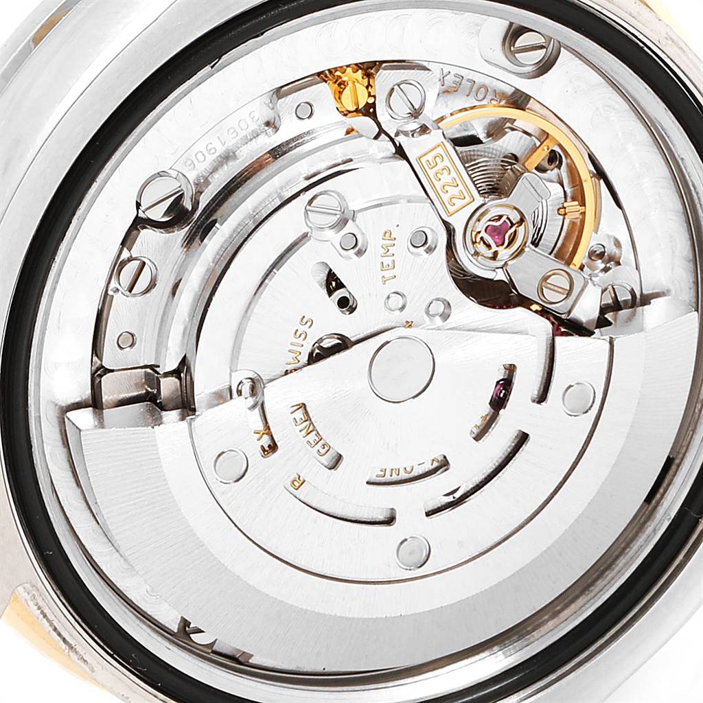 This image shows the inner mechanical movement of a Mid-Size Rolex watch from a back view.