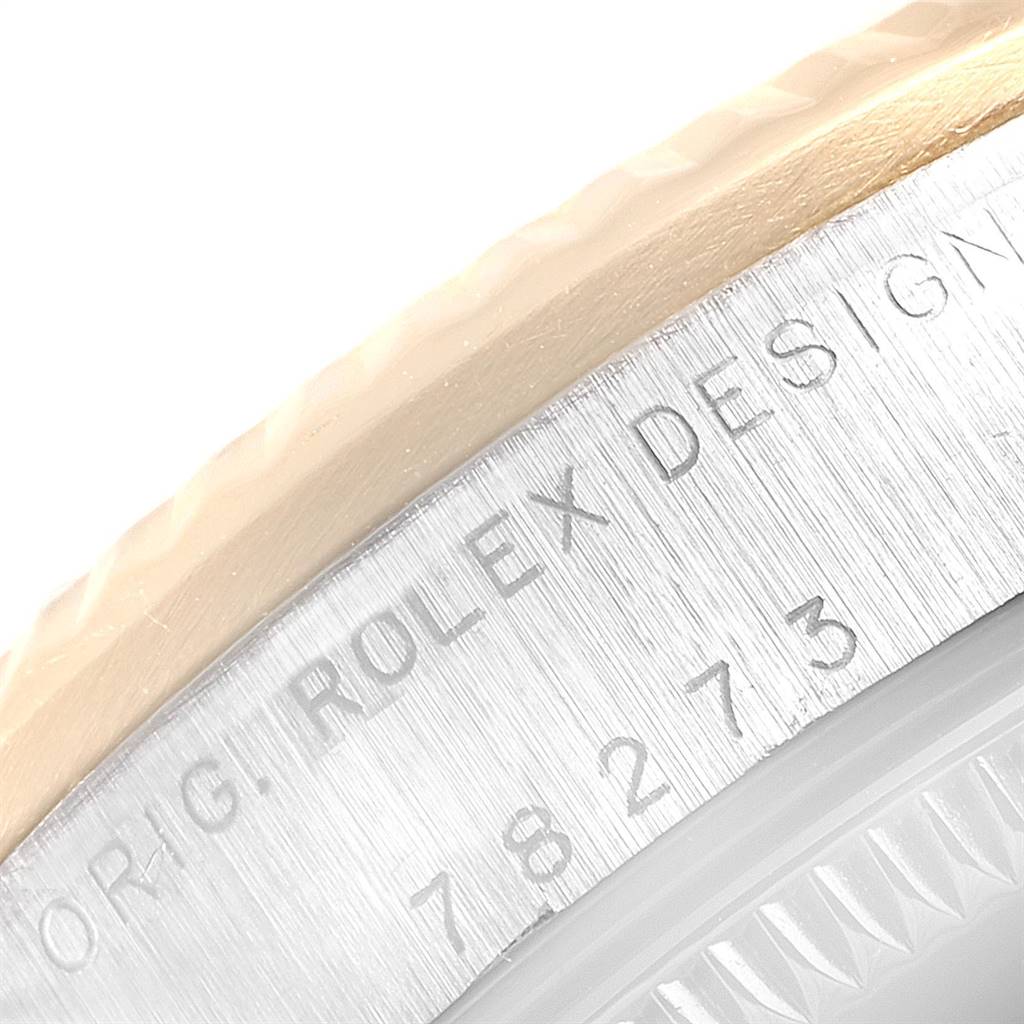 This image shows a close-up of the side bezel and serial engraving on the casing of a Rolex Mid-Size 178273 Women's Steel and Gold (two tone) Silver Dial 178273 Women's Steel and Gold (two tone) Silver Dial model watch.