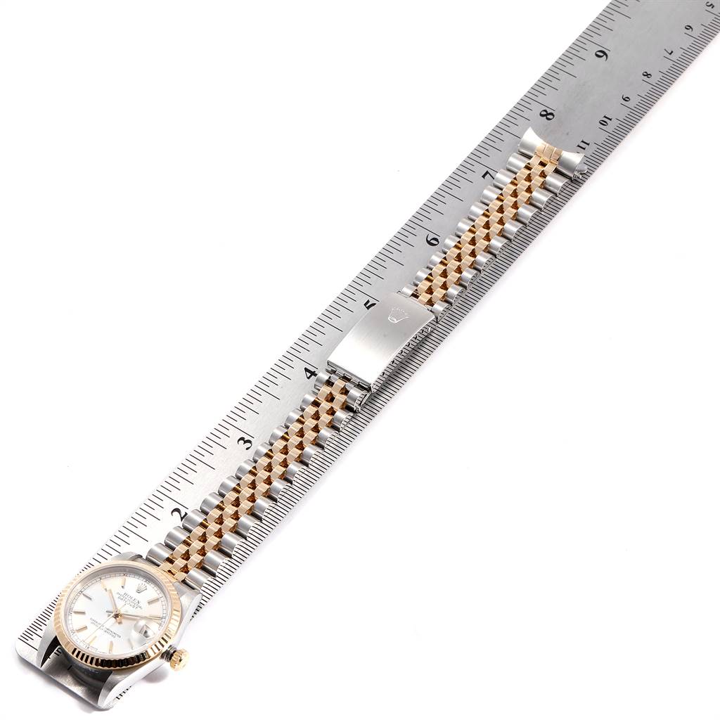 This image shows a Rolex Mid-Size 178273 Women's Steel and Gold (two tone) Silver Dial 178273 Women's Steel and Gold (two tone) Silver Dial watch from an overhead angle with the bracelet aligned along a ruler.
