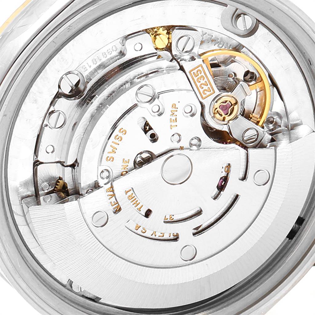 This image shows the intricate inner movement mechanism of a Mid-Size Rolex watch, viewed from the back.