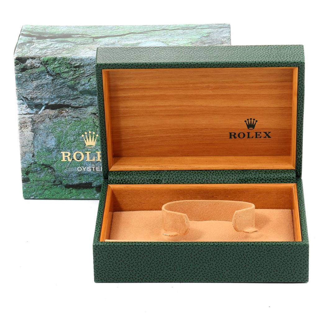 The image shows an open Rolex watch box for the Mid-Size model, featuring its green outer box and interior cushion.