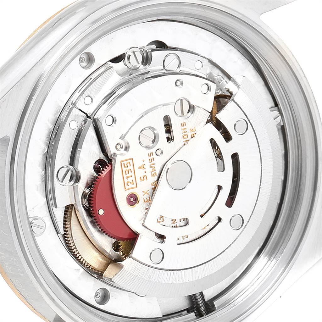 This image shows the intricate internal mechanism of a Mid-Size Rolex watch, viewed from the back.