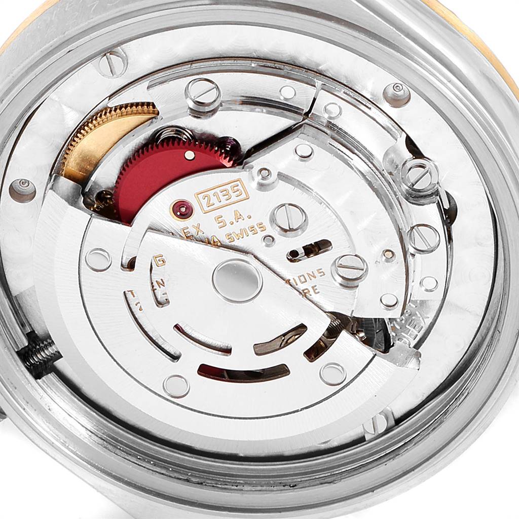 This image shows a close-up of the internal mechanism of a Mid-Size Rolex watch, specifically the movement components.