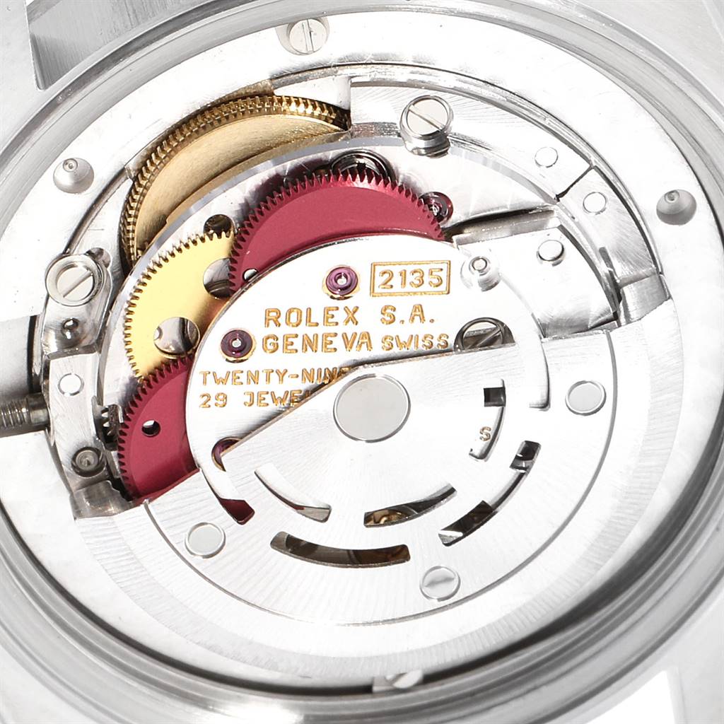 This is a close-up view of the internal movement of a Mid-Size Rolex watch, showcasing the mechanism and gears.
