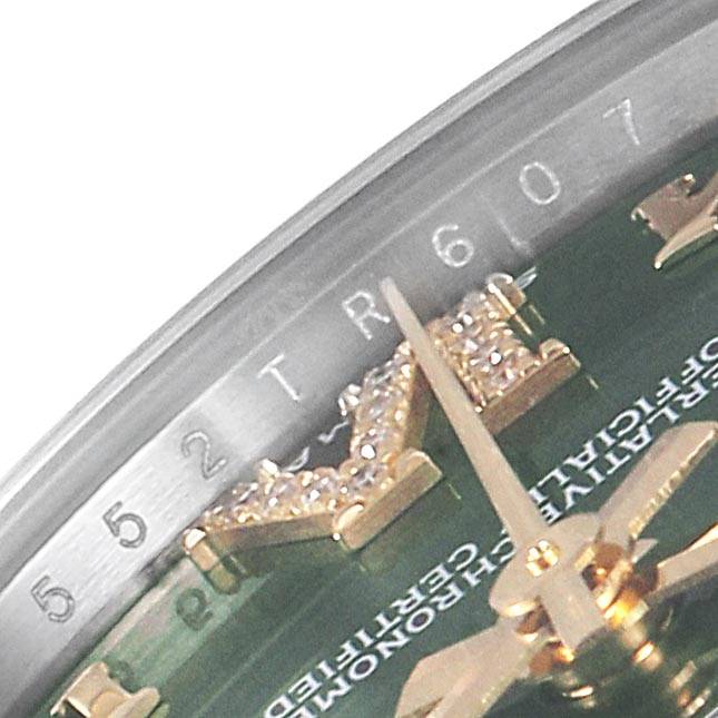 This close-up angle of the Rolex Mid-Size 178383 Women's Steel and Gold (two tone) Green Dial 178383 Women's Steel and Gold (two tone) Green Dial model shows the watch's dial, diamond hour markers, part of the hands, and the rehaut with inscription.