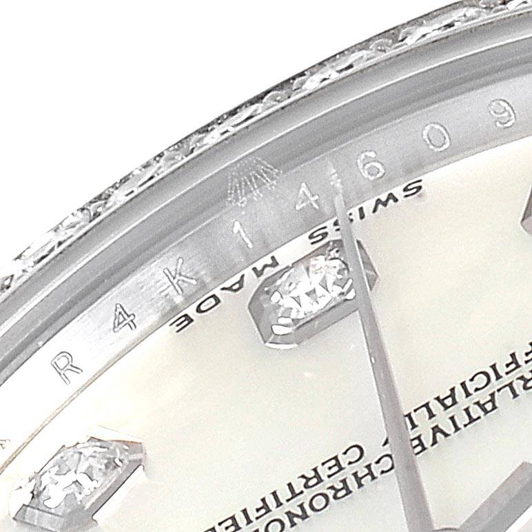 This image shows an angled close-up of the bezel, dial, and diamond hour marker of a mid-size Rolex watch.