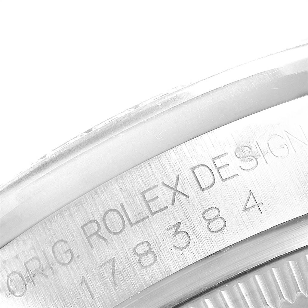 The close-up image shows the engraved model number and "ROLEX DESIGN" on the case back of the mid-size Rolex watch.