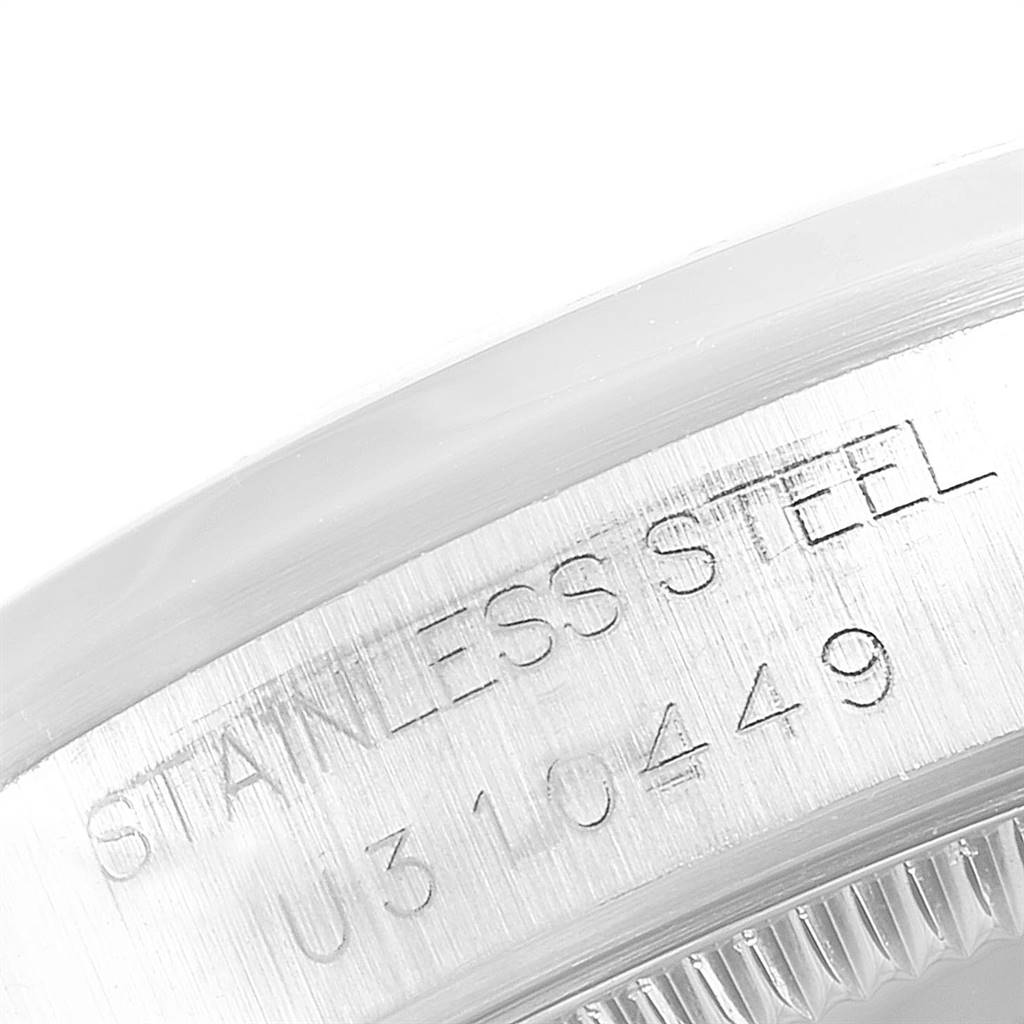 The image shows a close-up of the etched serial number and "STAINLESS STEEL" marking on the case of a Rolex Mid-Size 68240 Women's Stainless Steel Pink Dial 68240 Women's Stainless Steel Pink Dial model watch.