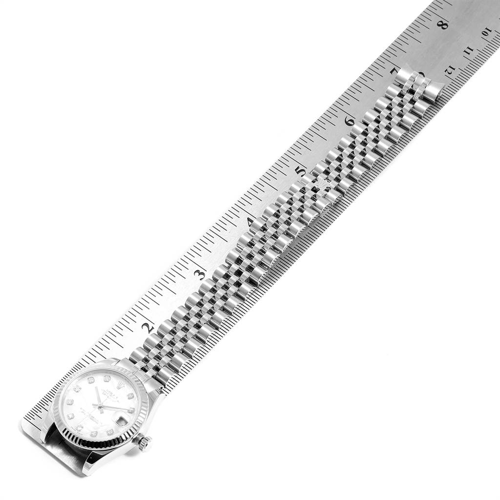 The Rolex Mid-Size 178274 Women's Stainless Steel Mother of Pearl Dial 178274 Women's Stainless Steel Mother of Pearl Dial watch is shown from a top view, displaying the face and full length of the band alongside a ruler for scale.